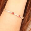 Half-Eternity 14K Gold Tennis Bracelet with Red Clover Aqeeq Stones on Wrist - side view