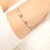 Close-up of Aqeeq and Pearl Clover 14K Gold Tennis Bracelet on wrist